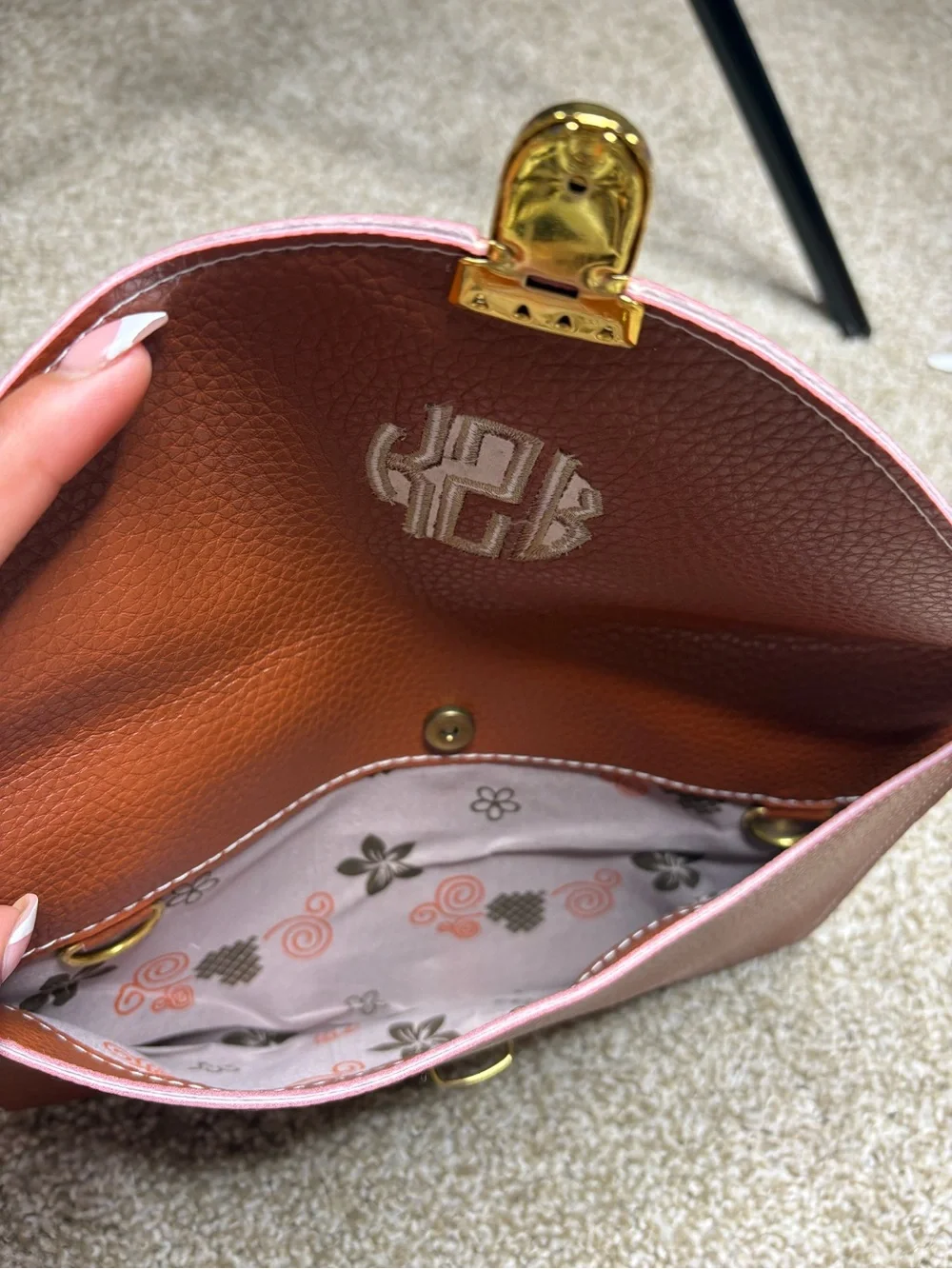Monogram Convertible Clutch in Rust Brown